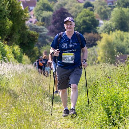 A man walking up a hill smiling