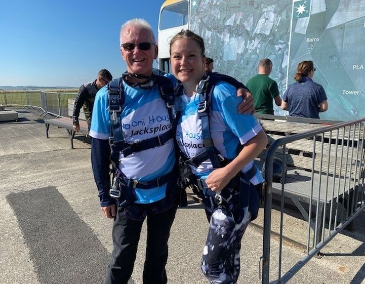 Man and women smiling together before their skydive jump