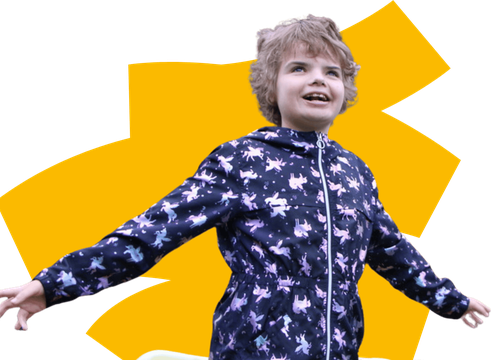 Girl stands with arms outstretched smiling with a graphic yellow swipe behind her