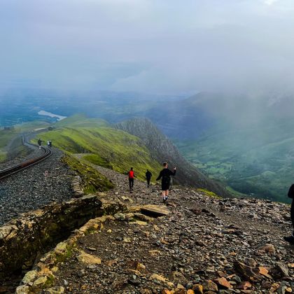 Looking down the summit of Snowdon to green hills
