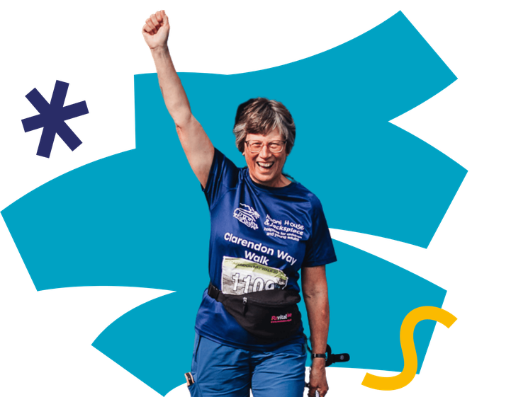 A lady smiling with a fist in the air