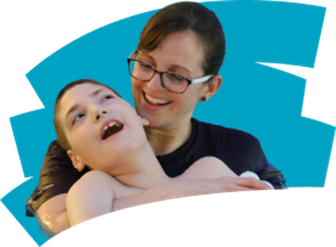 Physiotherapist smiling and holding boy, colourful background