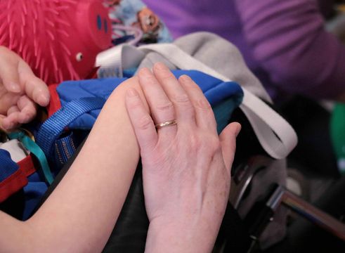 Two hands holding each other