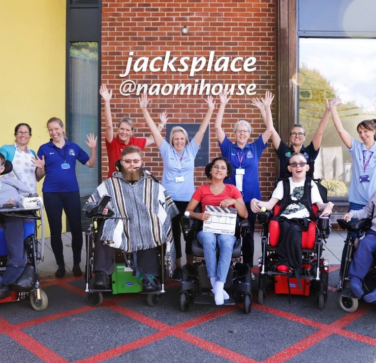 Young adults and staff in front of Jack's Place