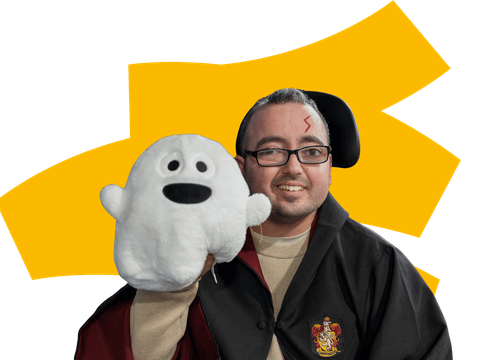 Young man dressed as Harry Potter holding ghost, colourful background